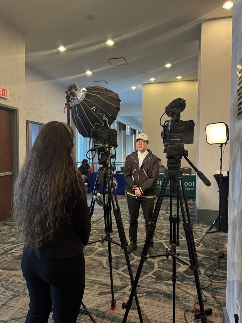 Founder being interviewed on camera by a professional film crew at the 2025 Alaska SBDC Summit in Anchorage.